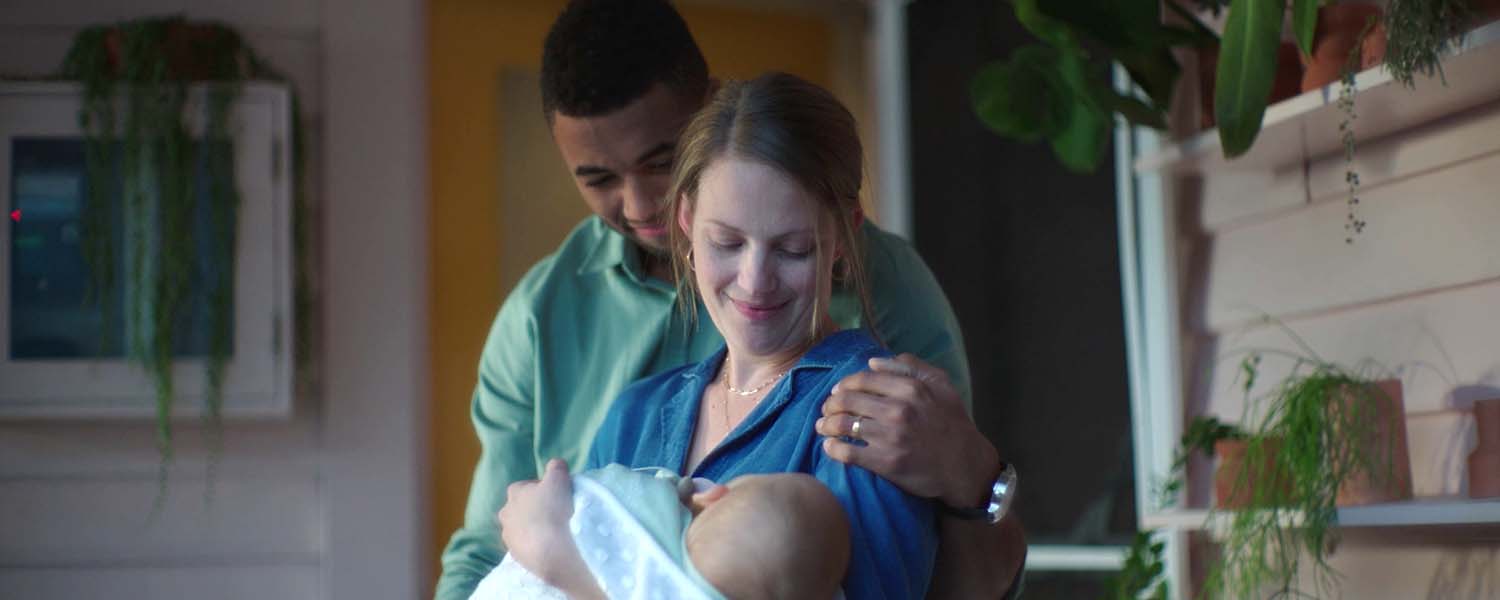 Young couple holding their newborn baby