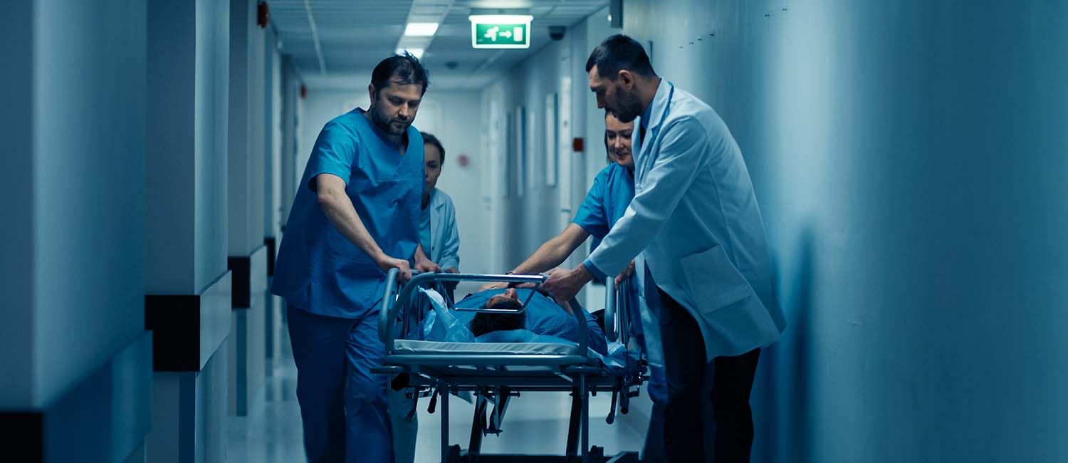 Doctors transporting a patient in a hospital corridor