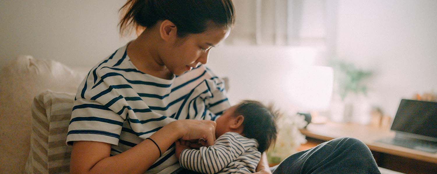 Young mother breastfeeding her baby